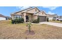 House exterior showcasing a two-car garage and manicured lawn at 11521 Sunder Berry St, Hudson, FL 34667