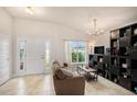 Bright living room with tiled floors, sofa, and built-in shelving at 11521 Sunder Berry St, Hudson, FL 34667