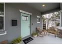 Quaint front porch with rocking chairs and potted plants at 117 W Minnehaha St, Tampa, FL 33604