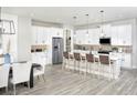 Spacious kitchen featuring white cabinets, island with seating, and stainless steel appliances at 12411 52Nd E St, Parrish, FL 34219