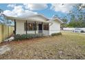 Newly renovated home with a front yard and a wooden fence at 1424 E Bougainvillea Ave, Tampa, FL 33612