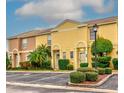 Tan and yellow townhomes with lush landscaping at 1505 Chateaux De Ville Ct, Clearwater, FL 33764