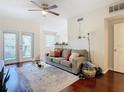 Living room with hardwood floors, a sofa, and access to a balcony at 2010 E Palm Ave # 14304, Tampa, FL 33605