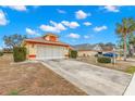 Front view of a single-story house with a two-car garage and driveway at 217 Linger Ln, Sun City Center, FL 33573