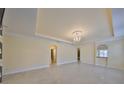 Bright living room with chandelier, tile floors and decorative wallpaper at 217 Oceania Ct, Apollo Beach, FL 33572