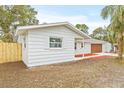 White house with new wood fence and landscaping at 2255 S Lagoon Cir, Clearwater, FL 33765