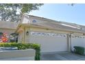 Two-story house with a white garage door and neatly trimmed shrubs at 2577 Estancia Blvd, Clearwater, FL 33761