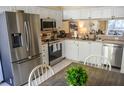 Modern kitchen featuring stainless steel appliances and white cabinets at 2577 Estancia Blvd, Clearwater, FL 33761