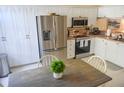 Bright kitchen with stainless steel appliances and white cabinets at 2577 Estancia Blvd, Clearwater, FL 33761