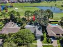 Aerial view of house, pool, and golf course community at 3147 Hyde Park Dr, Clearwater, FL 33761