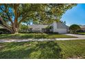 House exterior showcasing a spacious lawn and mature trees at 3147 Hyde Park Dr, Clearwater, FL 33761