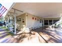 Carport and front entrance of a tan single-wide home at 37025 Karen Ave, Zephyrhills, FL 33542