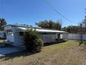 Single-wide mobile home with carport and fenced yard at 37402 Hammond Dr, Zephyrhills, FL 33541