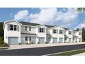 Five-unit townhome building with light blue exterior and attached garages at 4644 Pleasant Ave, Palm Harbor, FL 34683