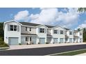 Five-unit townhome building with light blue exterior and attached garages at 4644 Pleasant Ave, Palm Harbor, FL 34683