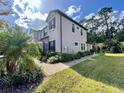 Side view of the two-story townhome, showcasing its design at 5110 San Martino Dr, Wesley Chapel, FL 33543