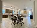 Open concept kitchen and living area with modern finishes at 5110 San Martino Dr, Wesley Chapel, FL 33543