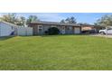 House with a spacious lawn and single-car garage at 6512 2Nd Ave Ne, Bradenton, FL 34208