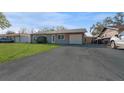 Front view of a ranch home with a driveway and carport at 6512 2Nd Ave Ne, Bradenton, FL 34208