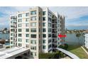 Waterfront condo building showcasing balconies and water views at 750 Island Way # 401, Clearwater Beach, FL 33767