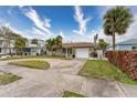 House with a circular driveway and palm trees at 809 Mandalay Ave, Clearwater Beach, FL 33767