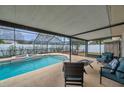 Relaxing screened patio area with comfortable seating overlooking a refreshing pool at 9923 119Th Way, Seminole, FL 33772