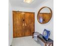 Bright entryway with wood doors and a round mirror at 1660 Gulf Blvd # 304, Clearwater Beach, FL 33767