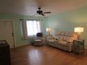 Living room features hardwood floors, light walls, and ample natural light at 1900 59Th N Ave # 212, St Petersburg, FL 33714