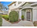 Inviting front entrance with lush landscaping and a charming walkway at 2104 Park Crescent Drive, Land O Lakes, FL 34639