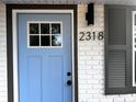 Light blue front door with black accents at 2318 Granada W Cir, St Petersburg, FL 33712