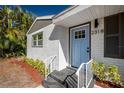 Light blue front door entrance to a newly renovated home with brick exterior at 2318 Granada W Cir, St Petersburg, FL 33712