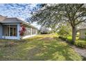 Spacious backyard with screened patio and lush greenery at 2440 E Del Webb Blvd, Sun City Center, FL 33573