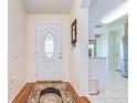 Bright entryway with hardwood floors and a view into the kitchen at 2440 E Del Webb Blvd, Sun City Center, FL 33573