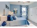 Cozy bedroom with a queen-size bed and blue color theme at 2565 Chapel Oak Bnd, Wesley Chapel, FL 33543