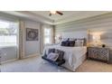 Spacious main bedroom with a king-size bed and ensuite bathroom at 2562 Chapel Oak Bnd, Wesley Chapel, FL 33543