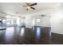 Open floor plan living area with dark hardwood floors at 3709 W Oklahoma Ave, Tampa, FL 33611