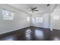 Bright living room featuring dark hardwood floors and two windows at 3709 W Oklahoma Ave, Tampa, FL 33611