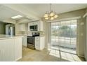 Eat-in kitchen with stainless steel appliances and sliding glass doors at 4173 Driver Ln, Port Charlotte, FL 33981