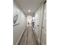 Long hallway with gray floors and artwork at 450 S Gulfview Blvd # 408, Clearwater Beach, FL 33767