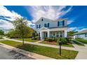 Two-story house on a tree-lined street with a manicured lawn at 5027 Autumn Ridge Dr, Wesley Chapel, FL 33545