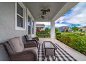 Relaxing front porch with seating and a ceiling fan at 5027 Autumn Ridge Dr, Wesley Chapel, FL 33545