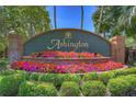 Ashton community entrance with brick pillars and colorful landscaping at 5103 Ashcrest Ct, Tampa, FL 33647