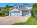 Two-story house with a large driveway and landscaped lawn at 5103 Ashcrest Ct, Tampa, FL 33647