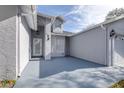 Front entry with light gray stucco and arched entryway at 5200 Lagos Ct, New Port Richey, FL 34655