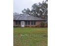 Brick building with a grassy yard at 6549 Brentwood Dr, Zephyrhills, FL 33542