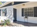 Updated front door with dark gray paint and new hardware at 6706 S Kissimmee St, Tampa, FL 33616