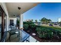 Private patio with seating area overlooking parking lot and water at 102 Mariner Dr, Tarpon Springs, FL 34689