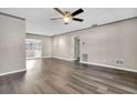 Bright living room with wood-look floors and access to a sunroom at 11320 114Th Ave, Largo, FL 33778