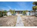 Charming single-story home with light blue exterior and a walkway at 117 73Rd Ave, St Pete Beach, FL 33706