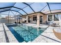 Relaxing pool and spa with a screened enclosure and outdoor dining area at 12292 Lyon Pine Ln, Odessa, FL 33556